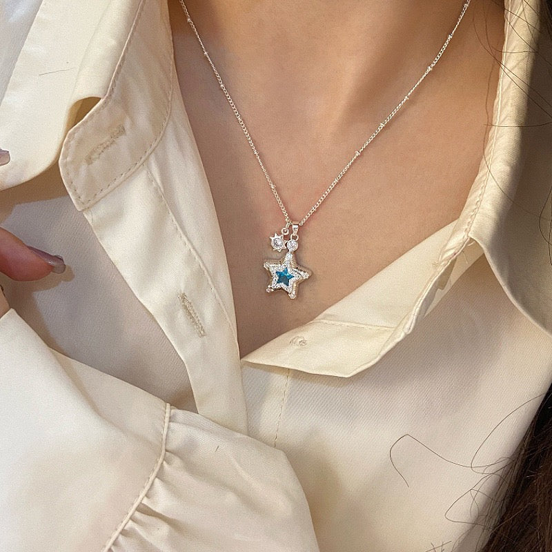 Star-themed earrings with zircon accents and a matching necklace set.